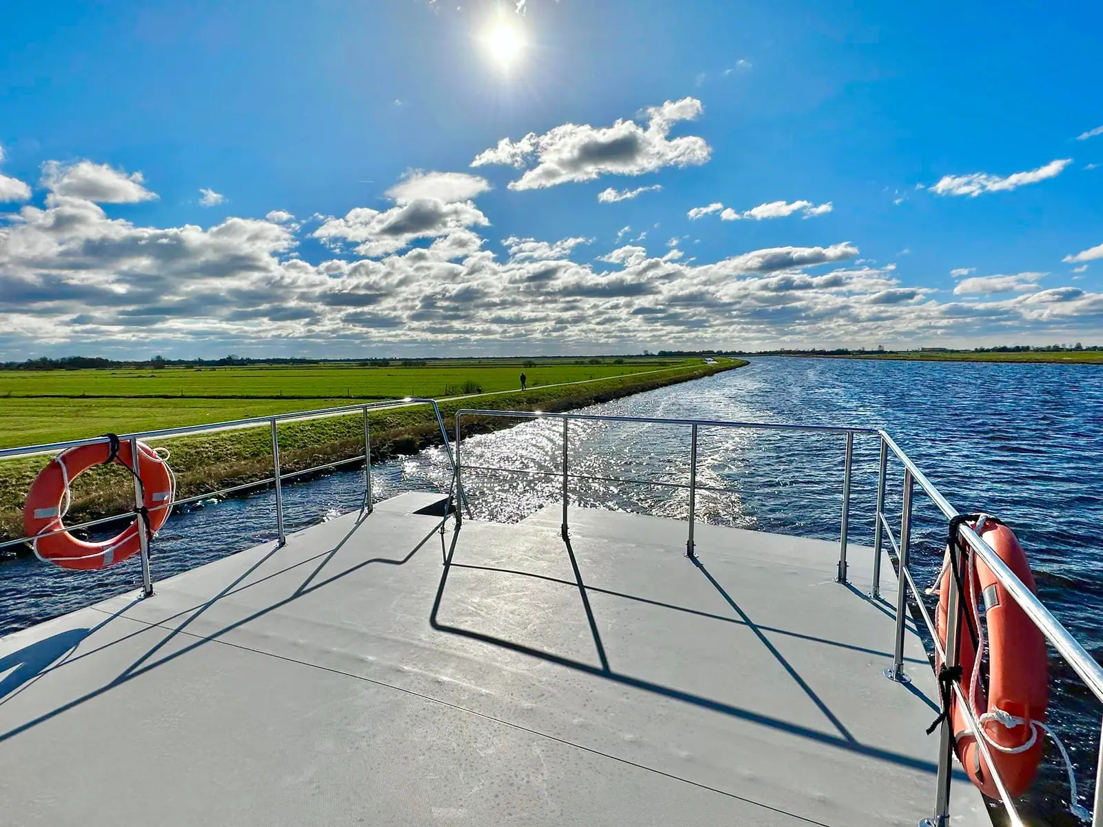 View from the foredeck of a boat cruising on an inland waterway